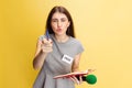 Emotional young girl, female reporter holding reporter microphone isolated on yellow studio background. Concept of