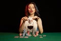 Emotional young lady in a white blouse drinking wine from a glass and playing cards Royalty Free Stock Photo