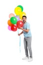 Emotional young man holding bunch of colorful balloons Royalty Free Stock Photo