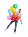 Emotional young man holding bunch of colorful balloons Royalty Free Stock Photo
