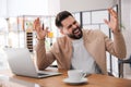 Emotional man working on laptop in office. Online hate concept