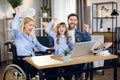 Handicapped woman using laptop for games with family