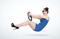 Emotional young woman in blue dress and sunglasses with a car steering wheel. Lady driver concept