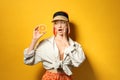 Emotional young woman with bright dyed hair holding orange half on color background Royalty Free Stock Photo