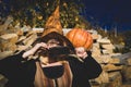 Emotional young woman in halloween costume on halloween party. Beautiful young woman in witches hat with pumpkin Royalty Free Stock Photo