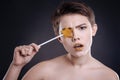 Emotional young woman posing with lollipop