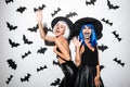 Emotional young women in halloween costumes Royalty Free Stock Photo