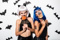 Emotional young women in halloween costumes Royalty Free Stock Photo