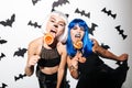 Emotional young women in halloween costumes Royalty Free Stock Photo