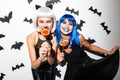 Emotional young women in halloween costumes Royalty Free Stock Photo