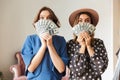 Emotional young women indoors holding money. Royalty Free Stock Photo