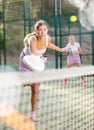 Young woman padel tennis player trains on the outdoor court Royalty Free Stock Photo