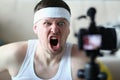 Emotionally angry sports blogger man screaming at camera