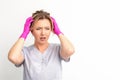 The emotionally shocked young female medical worker holding hands on her head fell into panic on white background Royalty Free Stock Photo