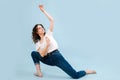 Emotionless dancer with legs in a lunge, body twisted in opposite direction Royalty Free Stock Photo