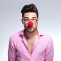 Emotionless fashion young man with red nose Royalty Free Stock Photo