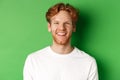 Emotions and fashion concept. Happy young man with red hair and beard, smiling and laughing at camera, standing over Royalty Free Stock Photo