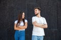 Offended Caucasian man and woman looking at each other and standing in white T-shirts with arms Royalty Free Stock Photo