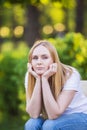 Emotions of the girl, fatigue, boredom, depression, sadness. Attractive bored young blond Caucasian woman holding her head with ha