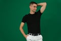 Studio portrait of handsome man showing his muscles emotions of a handsome man guy on a green background chromakey close Royalty Free Stock Photo