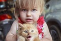 Emotions, little girl with a little red kitten Royalty Free Stock Photo