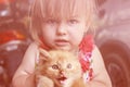 Emotions, little girl with a little red kitten Royalty Free Stock Photo