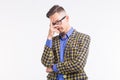 Emotions and people concept - handsome young man in jacket with beard and whisker in glasses thinking about something Royalty Free Stock Photo