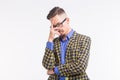 Emotions and people concept - handsome young man in jacket with beard and whisker in glasses thinking about something Royalty Free Stock Photo