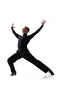 Portrait of young graceful male dancer, flexible man in black stage costume dancing ballroom dance isolated on white Royalty Free Stock Photo