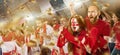 Emotive football, soccer fans from England cheering their team with white red scarfs at stadium. Concept of sport Royalty Free Stock Photo