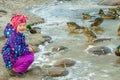 Emotions of a small child at the sight of wild mallards on a freezing river