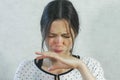 Emotions from the sour on the girl`s face. Brunette woman eating sour tangerine and wincing. Royalty Free Stock Photo