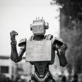 Emotive Exoskeleton: A Vintage Cinematic Metal Robot Holding A Sign