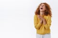 Emotive, happy redhead woman with curly hair, laughing out loud, lift head up, close eyes, cant stop chuckling, clasp