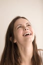 Emotive headshot portrait of joyful young woman