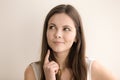 Emotive headshot portrait of pensive young woman