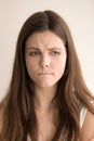 Emotive headshot portrait of sad young woman