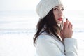 Emotive portrait of fashionable model in white coat and beret Royalty Free Stock Photo