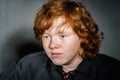 Emotive portrait of red-haired freckled boy, childhood concept