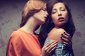 Emotive portrait of two gorgeous girlfriends in blue and orange Royalty Free Stock Photo