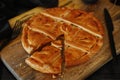 Empanada Gallega, traditional pie stuffed with tuna or meat typical of Galicia, Spain, on a wooden background