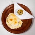 Chilean empanada accompanied by pebre sauce