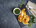 Empanadas with chimichuri sauce. Traditional Latin American cuisine.