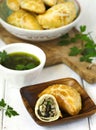 Empanadas with chimichurri sauce.