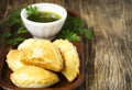 Empanadas with chimichurri sauce.