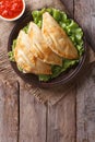 Empanadas and sauce closeup. vertical top view, rustic