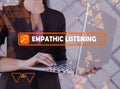 EMPATHIC LISTENING phrase on the screen. Bookkeeping clerk use internet technologies at office. Concept search and EMPATHIC