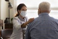 Empathic young female doctor hold hand on elderly patient shoulder Royalty Free Stock Photo