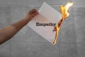 Empathy text on burning paper