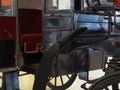 Vintage vehicle carriage caretaker abandoned emperor comfort wheel spokes tree metal road fan Royalty Free Stock Photo